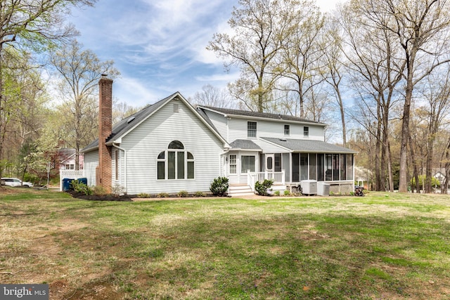 5855 Springmount Ct, Eldersburg, MD 21784 - back of property featuring roof with shingles, central AC unit, a chimney, a lawn, and a sunroom