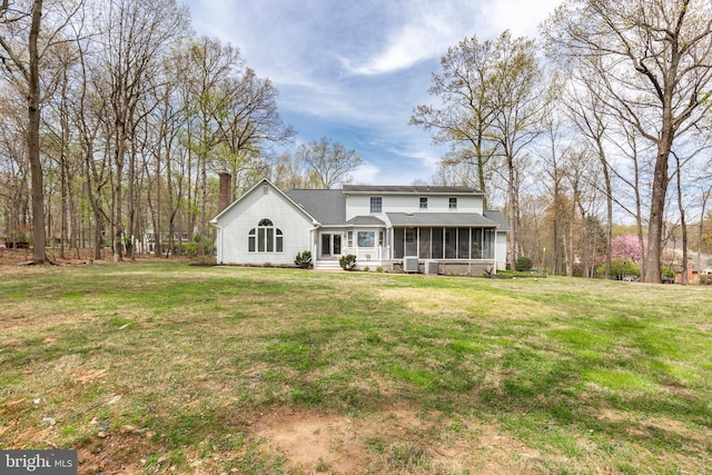 5855 Springmount Ct, Eldersburg, MD 21784 - rear view of property with a chimney, roof with shingles, a sunroom, and a yard