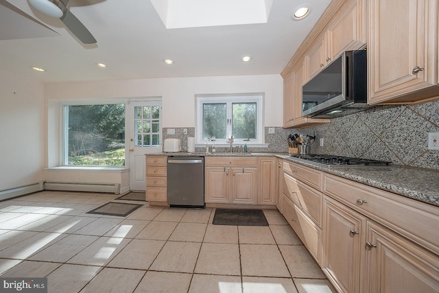 kitchen featuring stainless steel appliances, light brown cabinetry, decorative backsplash, light tile patterned floors, and recessed lighting
