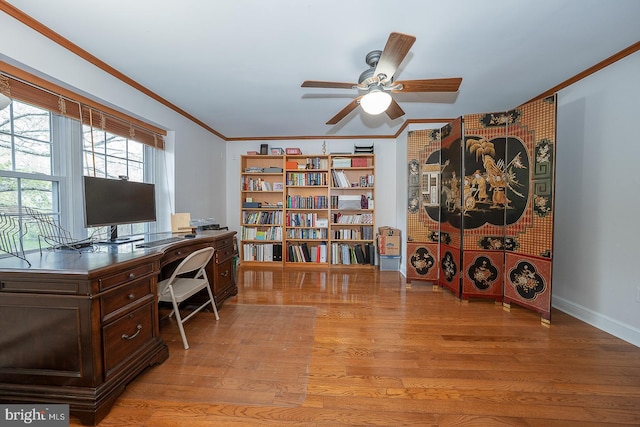 office with crown molding, a ceiling fan, and light wood finished floors