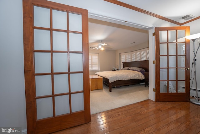 bedroom with hardwood / wood-style flooring and ornamental molding