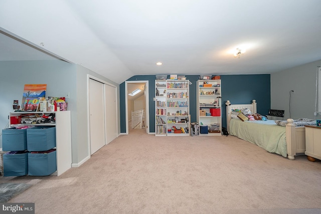 carpeted bedroom with lofted ceiling
