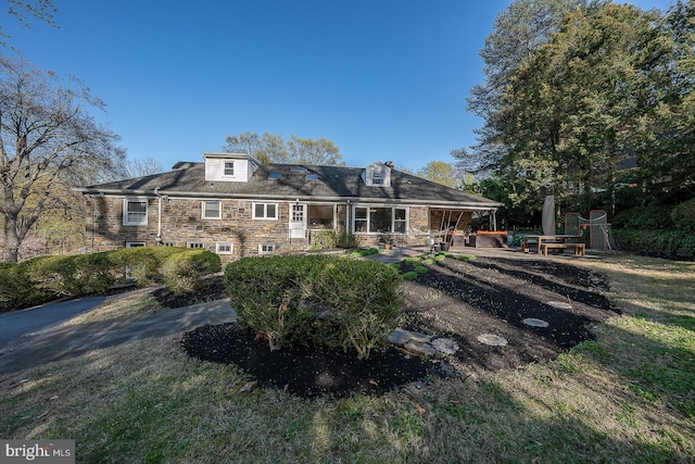 back of house with a patio area and stone siding