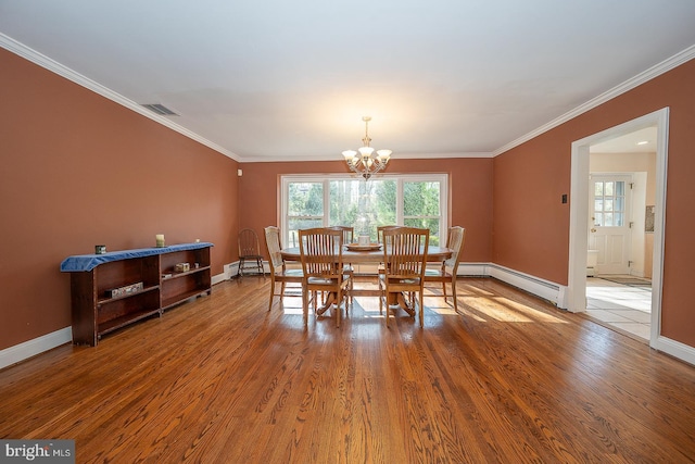 dining room with baseboards, a notable chandelier, ornamental molding, and visible vents