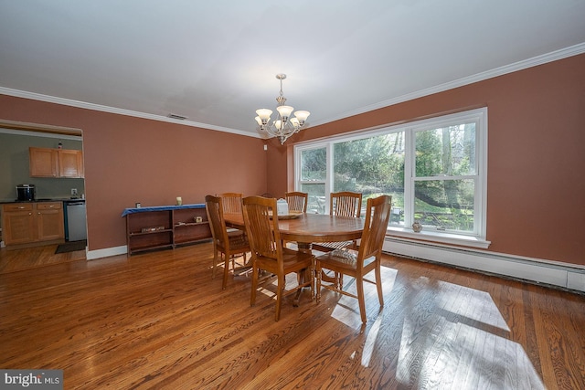 dining space featuring crown molding, wood finished floors, a baseboard heating unit, and a notable chandelier