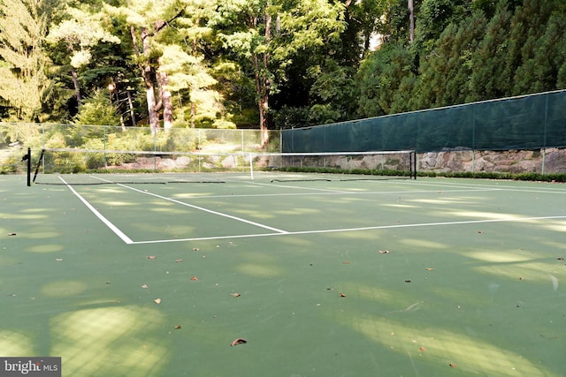 view of sport court featuring fence