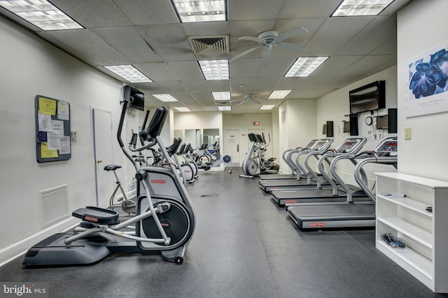 workout area with ceiling fan, a drop ceiling, and visible vents