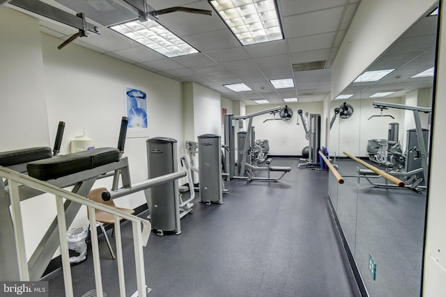 gym with a paneled ceiling