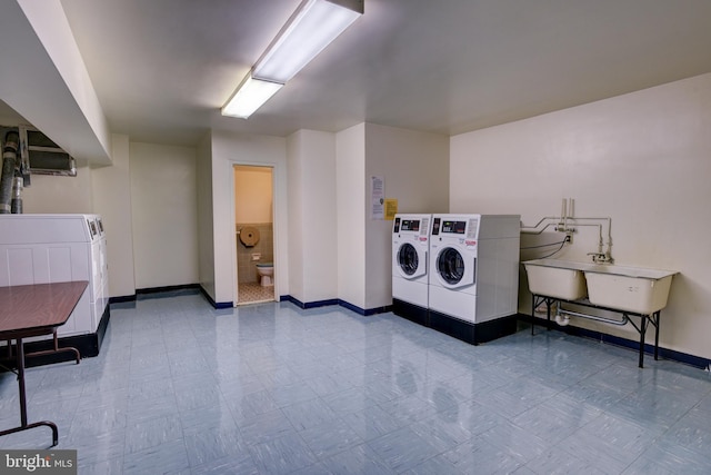 common laundry area featuring baseboards and separate washer and dryer