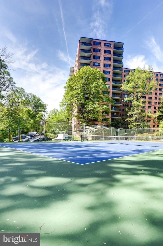 view of tennis court featuring fence