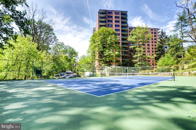 view of tennis court featuring fence