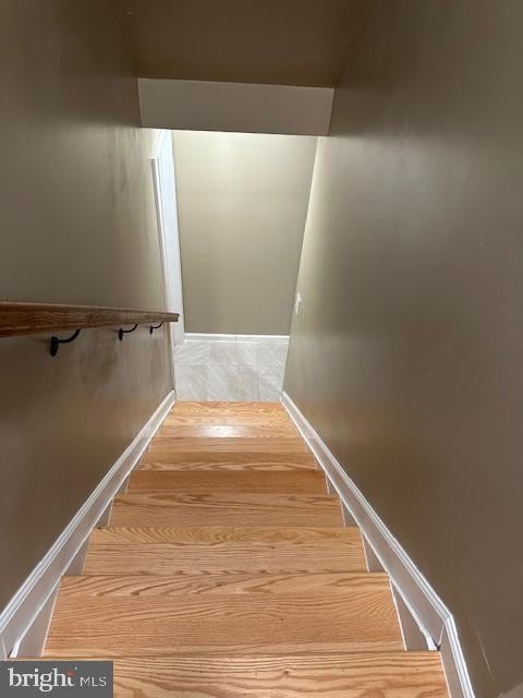 stairs with baseboards and wood finished floors