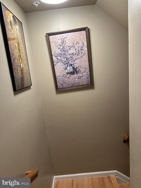 interior space featuring baseboards and wood finished floors