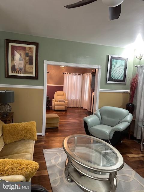 sitting room featuring ceiling fan and wood finished floors