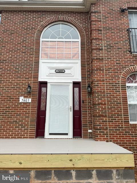 entrance to property with brick siding