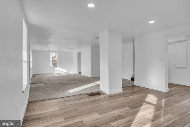 below grade area featuring baseboards, wood finished floors, and recessed lighting