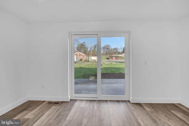 interior space featuring wood finished floors and baseboards