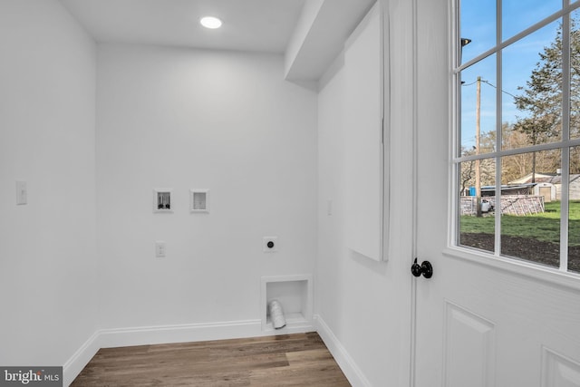 clothes washing area with hookup for a washing machine, wood finished floors, hookup for an electric dryer, baseboards, and laundry area