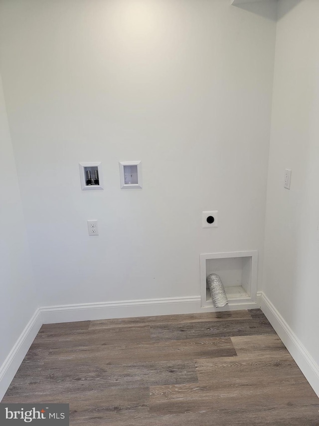 laundry area with laundry area, hookup for a washing machine, wood finished floors, hookup for an electric dryer, and baseboards