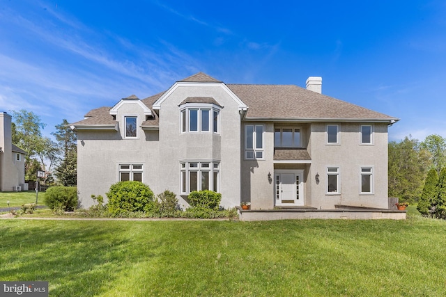 1406 Gentlemens Way, Dresher, PA 19025 - back of property featuring a chimney, a yard, a shingled roof, and stucco siding