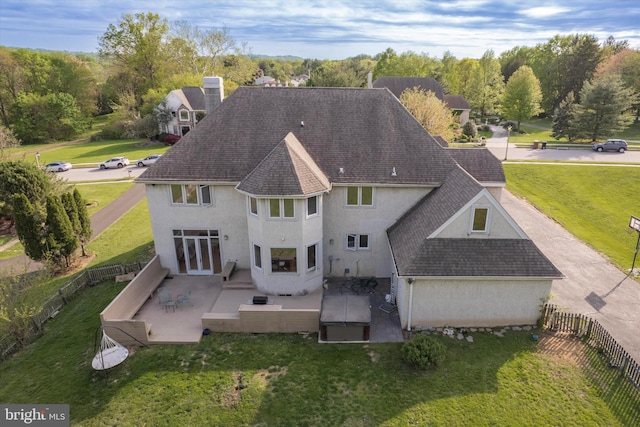 1406 Gentlemens Way, Dresher, PA 19025 - back of property featuring stucco siding, a patio, roof with shingles, and a fenced backyard