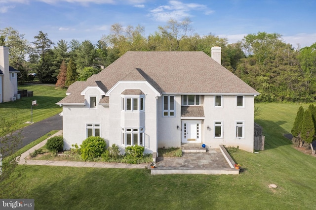 1406 Gentlemens Way, Dresher, PA 19025 - view of front of house featuring a front yard, a chimney, roof with shingles, stucco siding, and a patio