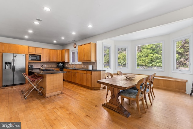1406 Gentlemens Way, Dresher, PA 19025 - kitchen with stainless steel fridge, black microwave, dark countertops, decorative backsplash, and recessed lighting