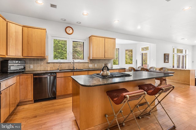 1406 Gentlemens Way, Dresher, PA 19025 - kitchen with stainless steel dishwasher, dark countertops, a kitchen breakfast bar, a kitchen island, and healthy amount of natural light