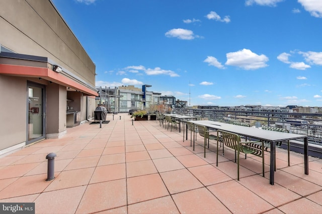 view of patio / terrace featuring a view of city and a grill