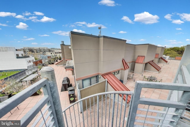 rear view of property with a balcony and stucco siding