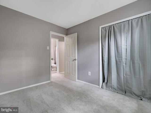 unfurnished bedroom with carpet and baseboards