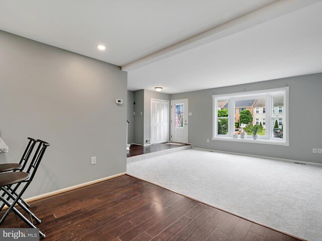unfurnished living room featuring wood finished floors, baseboards, and recessed lighting