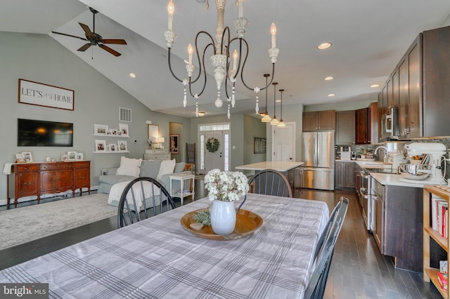 dining room with recessed lighting, dark wood-style floors, visible vents, high vaulted ceiling, and ceiling fan with notable chandelier