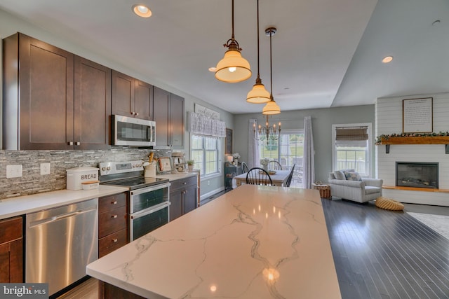 kitchen featuring recessed lighting, hanging light fixtures, appliances with stainless steel finishes, and decorative backsplash