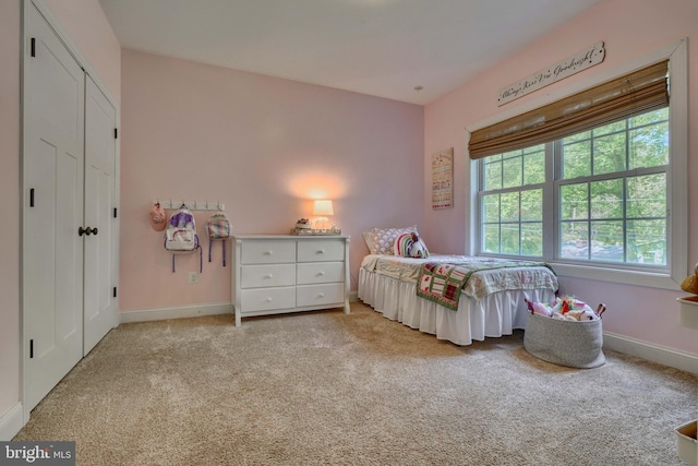 bedroom featuring baseboards and carpet flooring