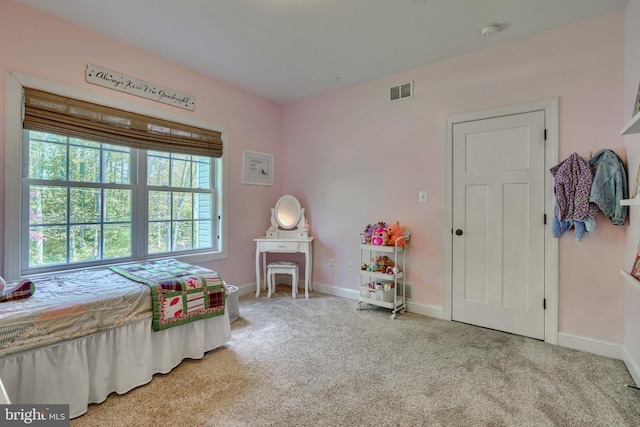 carpeted bedroom with visible vents and baseboards