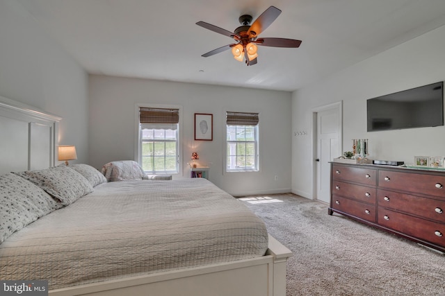 bedroom with baseboards, a ceiling fan, and light colored carpet
