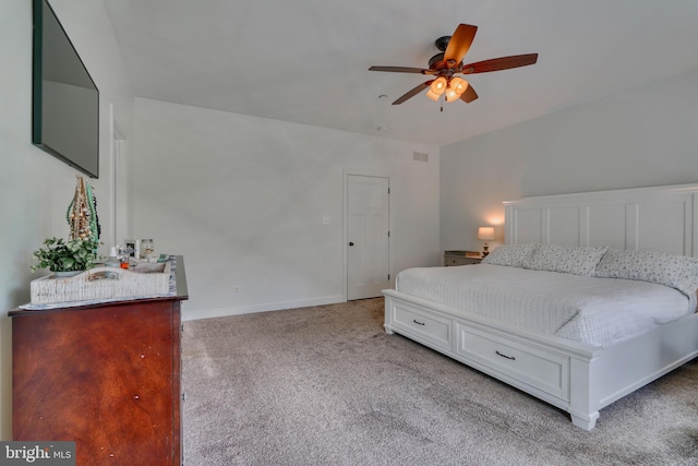 bedroom featuring light carpet, a ceiling fan, visible vents, and baseboards