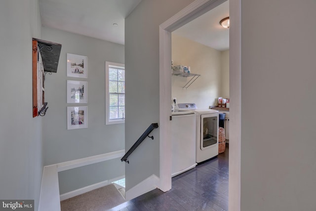 interior space with washing machine and dryer, baseboards, dark wood-type flooring, and laundry area