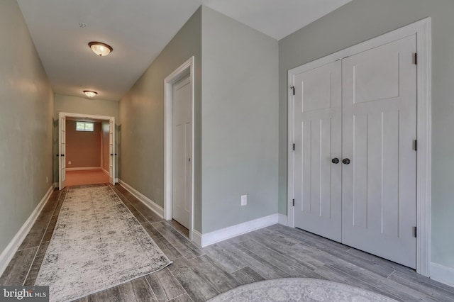 interior space featuring wood finished floors and baseboards