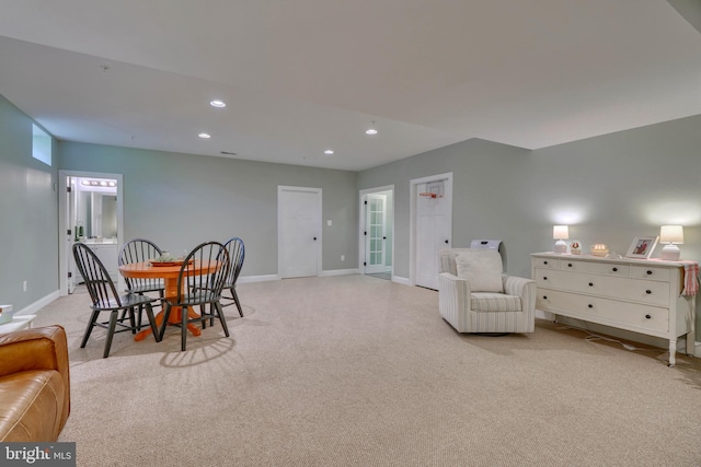 sitting room with baseboards, light carpet, and recessed lighting