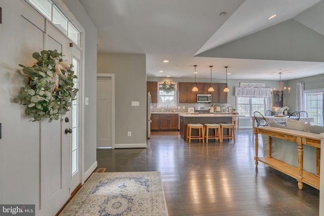 foyer with recessed lighting, baseboards, dark wood-style floors, and a notable chandelier