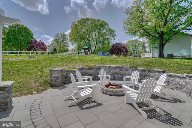 view of patio featuring a fire pit and fence