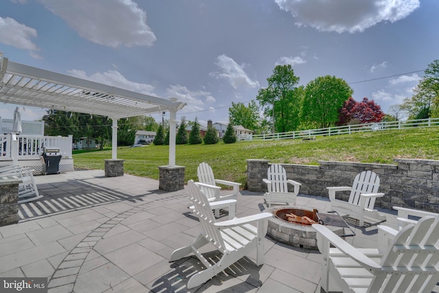 view of patio with fence, a pergola, and an outdoor fire pit
