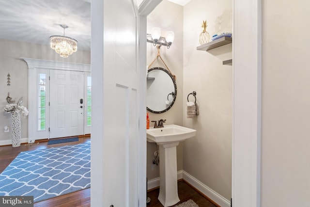 765 Blueberry Ct, Huntingtown, MD 20639 - foyer featuring baseboards, an inviting chandelier, and wood finished floors