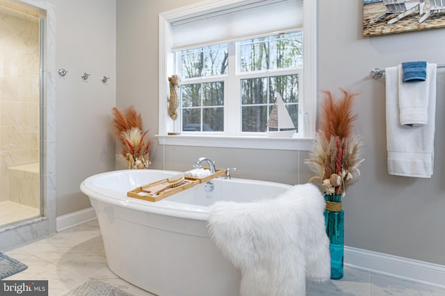 765 Blueberry Ct, Huntingtown, MD 20639 - full bath featuring a soaking tub, baseboards, marble finish floor, and a stall shower