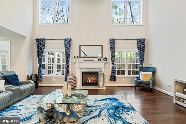 765 Blueberry Ct, Huntingtown, MD 20639 - living area featuring a fireplace with flush hearth, a high ceiling, baseboards, and wood finished floors