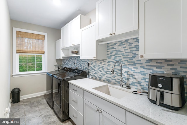 765 Blueberry Ct, Huntingtown, MD 20639 - laundry room with washer and dryer, baseboards, a sink, and cabinet space