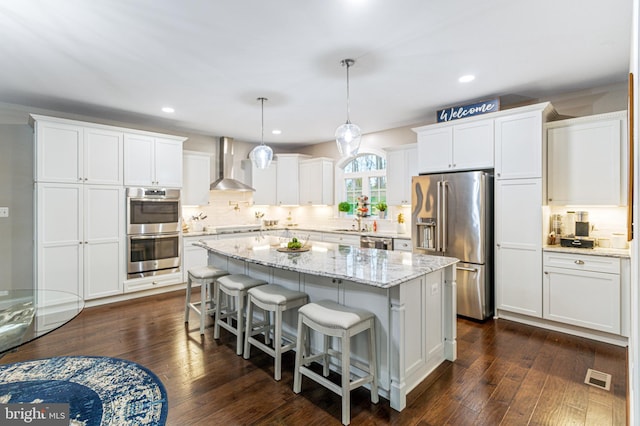 765 Blueberry Ct, Huntingtown, MD 20639 - kitchen with wall chimney range hood, white cabinets, visible vents, and stainless steel appliances