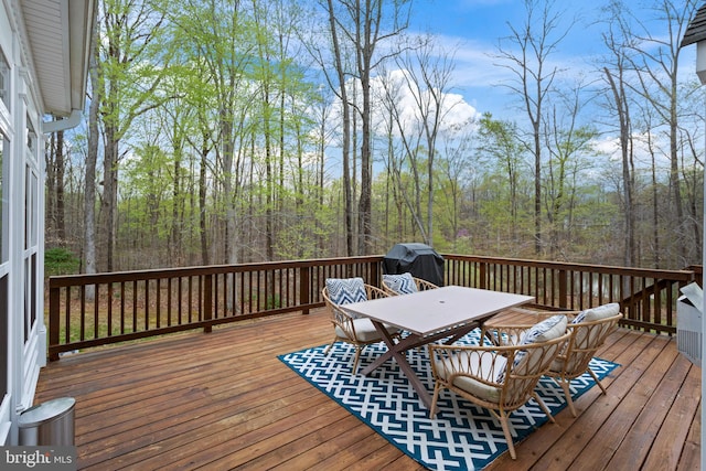 765 Blueberry Ct, Huntingtown, MD 20639 - wooden deck featuring outdoor dining area, a forest view, and a grill
